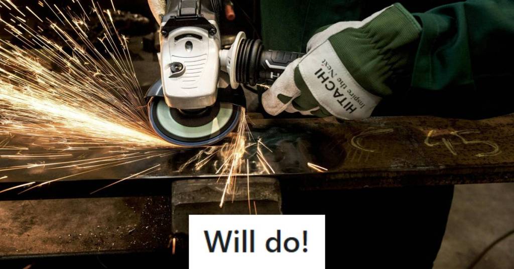 Man wearing gloves and using a saw to cut through steel