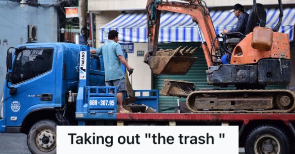 Truck carrying a small excavator for a construction work in the local neighborhood