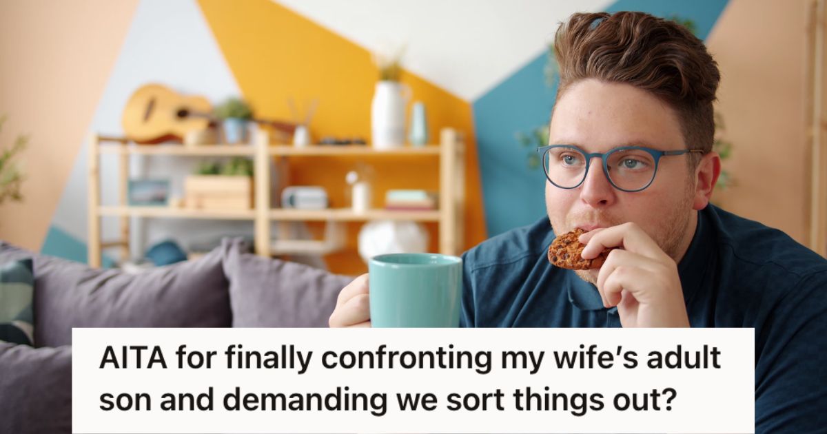 Man eating cookies and holding a cup while sitting and watching TV