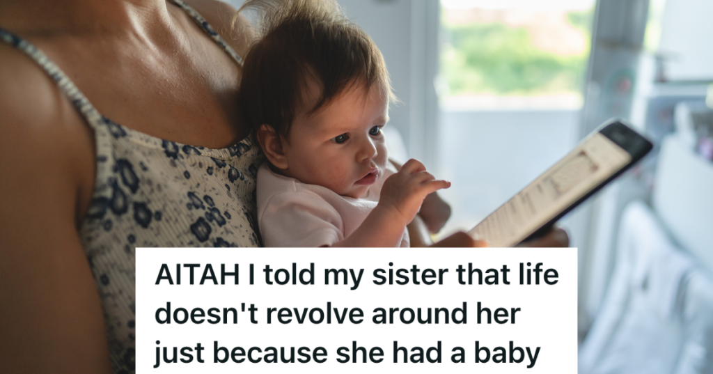 woman holding baby and looking at phone