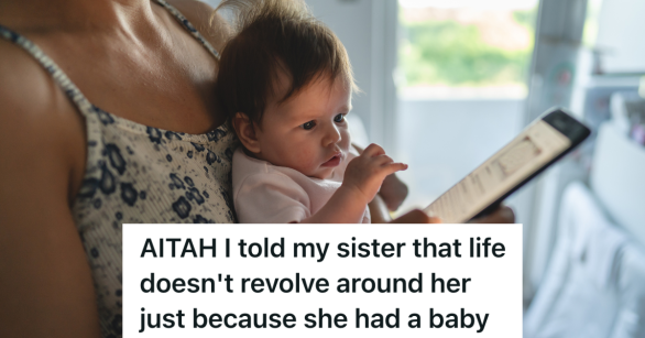 woman holding baby and looking at phone