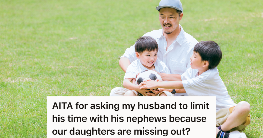 man and two boys holding soccer ball at the park