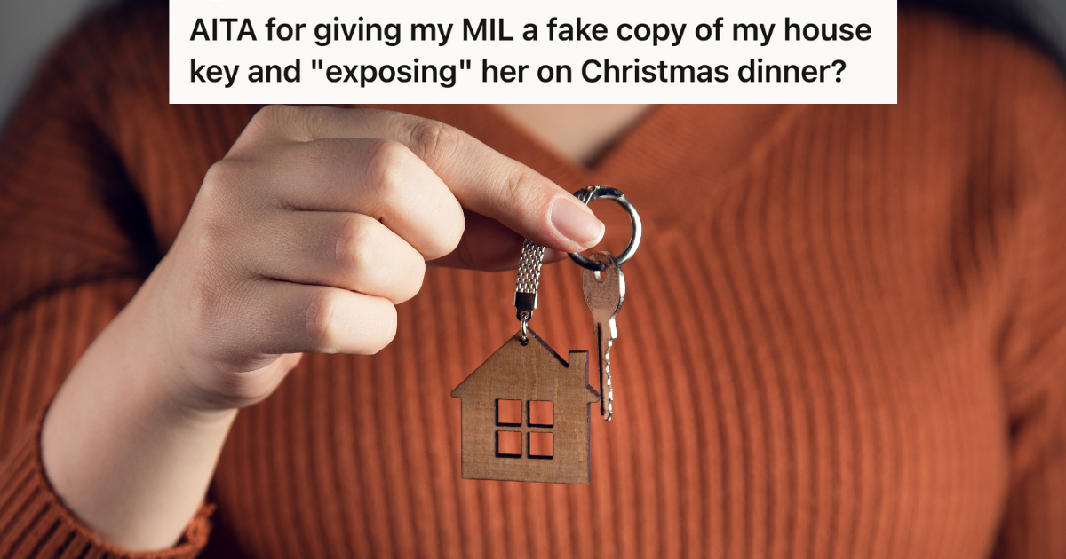 closeup of woman's hand holding key with a house keychain