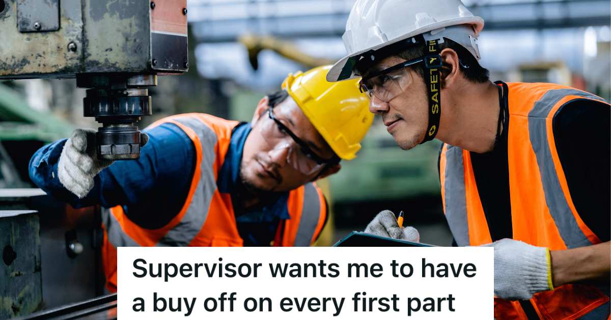 two men in hardhats looking at a machine