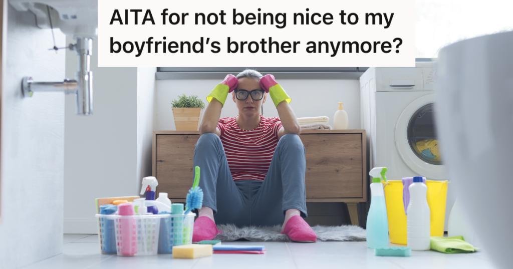 frustrated woman sitting on the floor with cleaning supplies