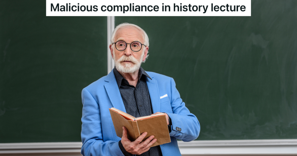 old professor in blue jacket and glasses holding a book