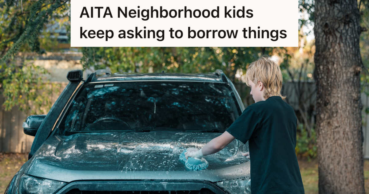 teenage boy washing car with sponge