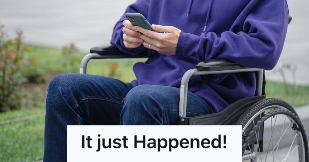 Man in purple sweatshirt sitting on a wheelchair and holding his phone