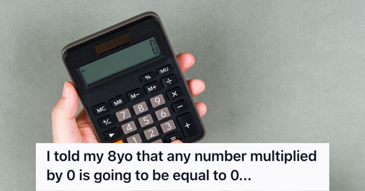 Person holding a calculator with zero on the screen