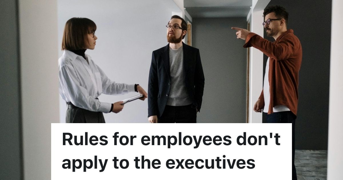 Three workers standing talking and dressed casually