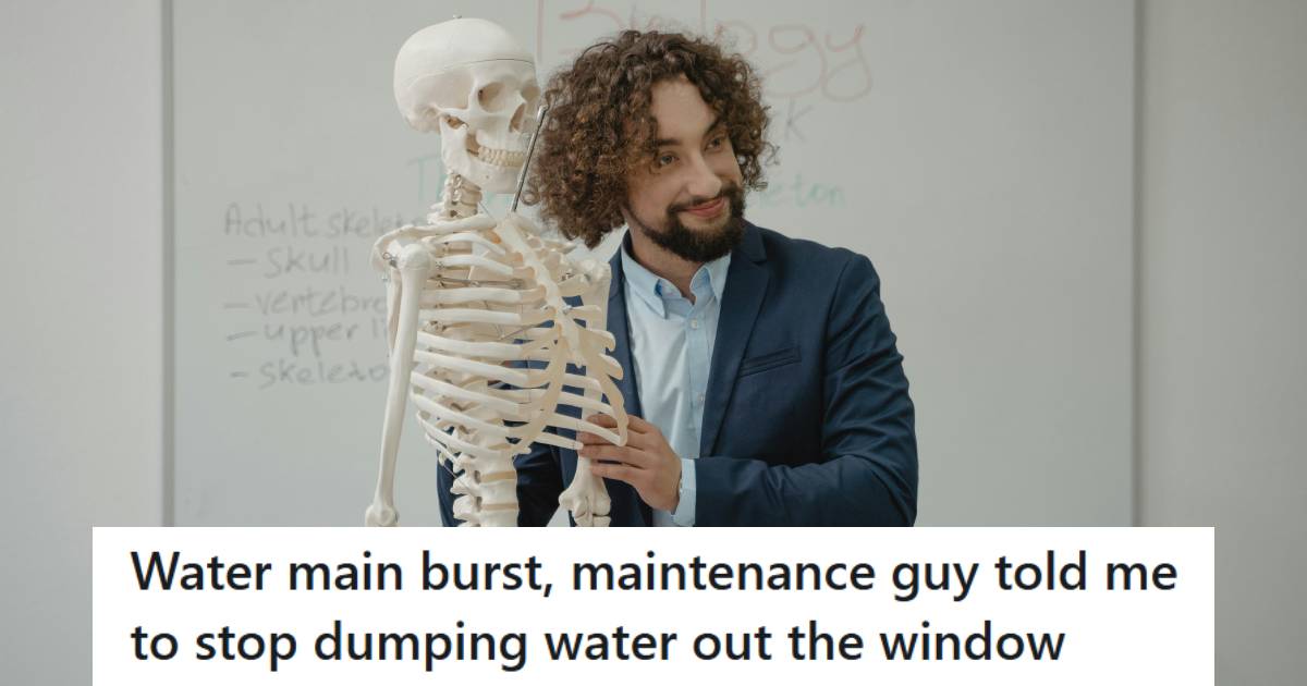 Science Teacher holding a skeleton as he teaches class