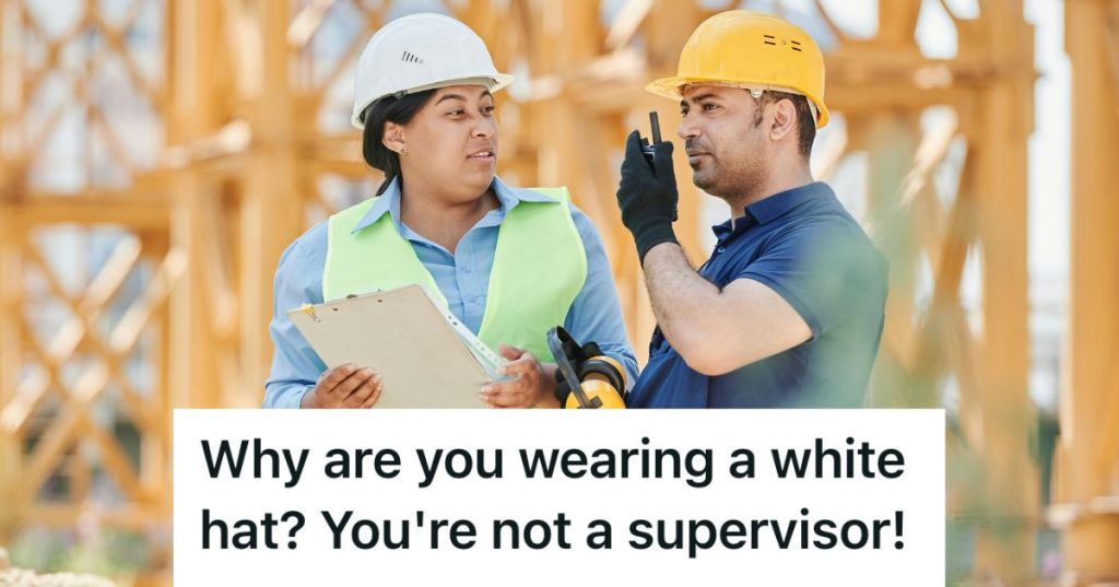 Two people in white and yellow hard hats in a site