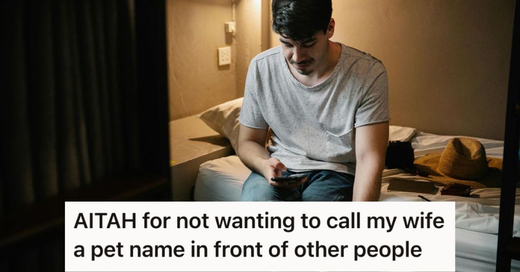 Man sitting on the bed looking at his phone