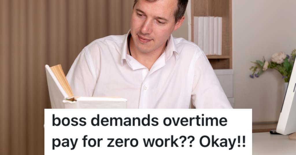 man reading a book at his desk