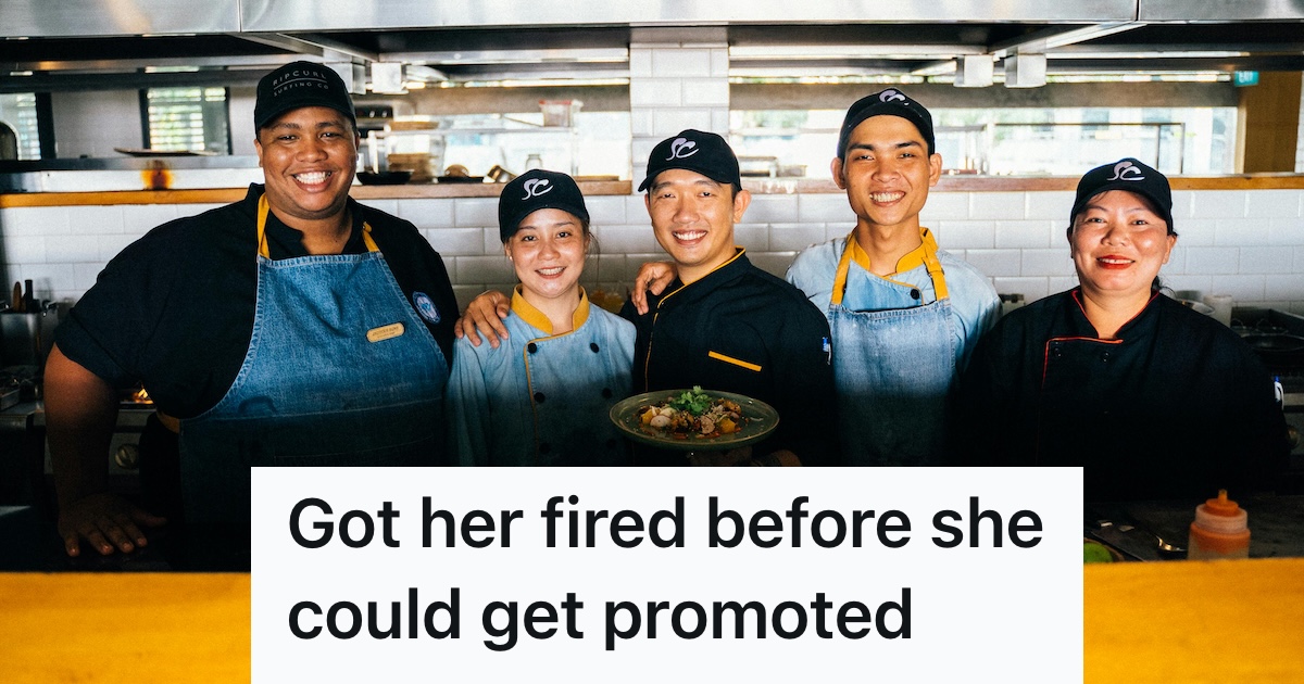 Restaurant crew posing with food in the kitchen
