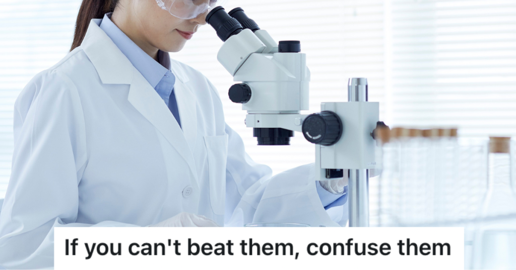 woman scientist looking into microscope wearing a lab coat.