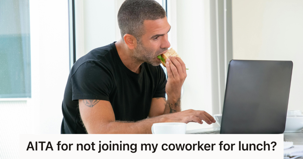 man eating a sandwich while on the computer
