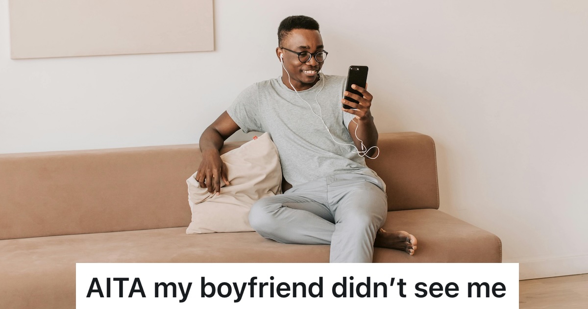 man looking at phone on the couch