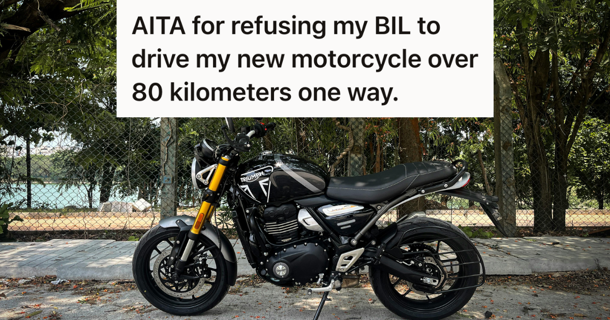 new motorcycle against a chain link fence