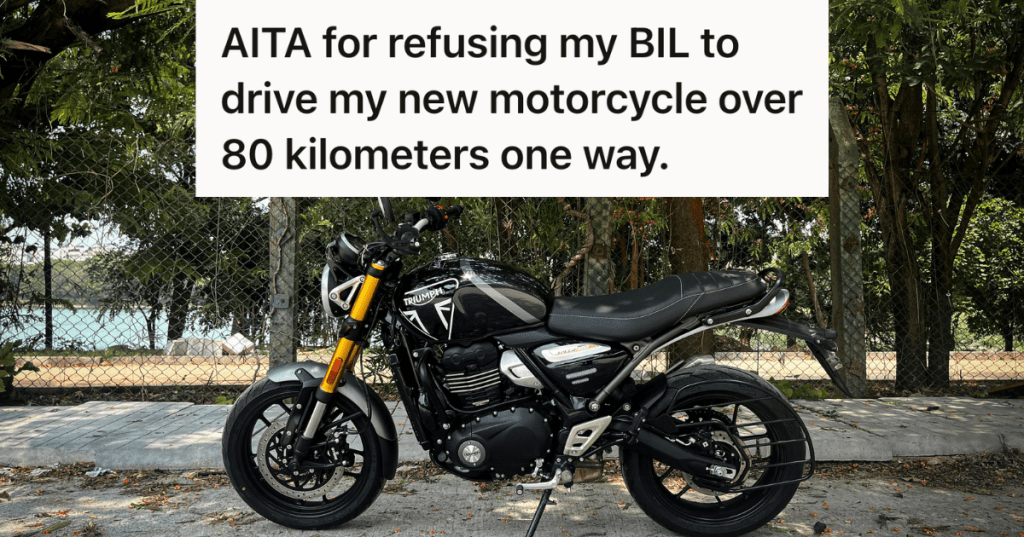 new motorcycle against a chain link fence