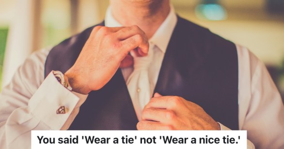 man straightening his tie