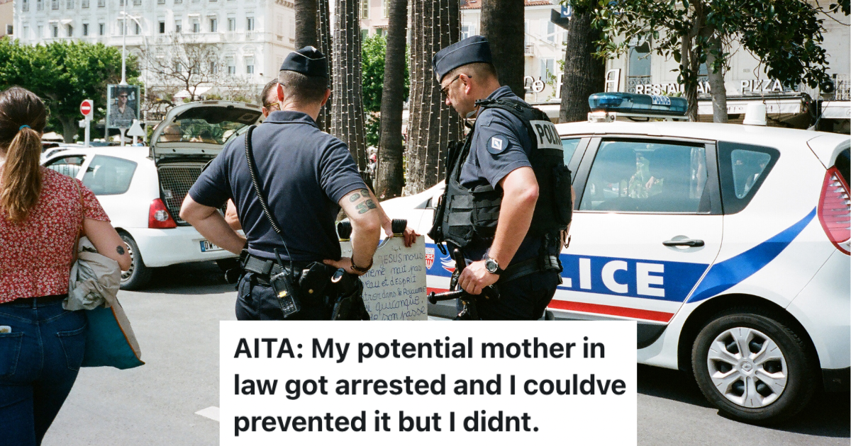 two cops talking to a person on the street.