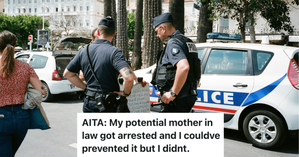 two cops talking to a person on the street.