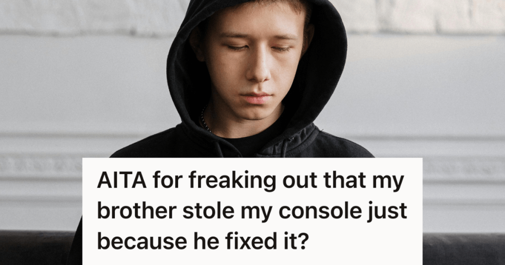 sad teen boy in black hoodie looking down