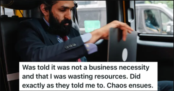 Man sitting in a car working on a laptop