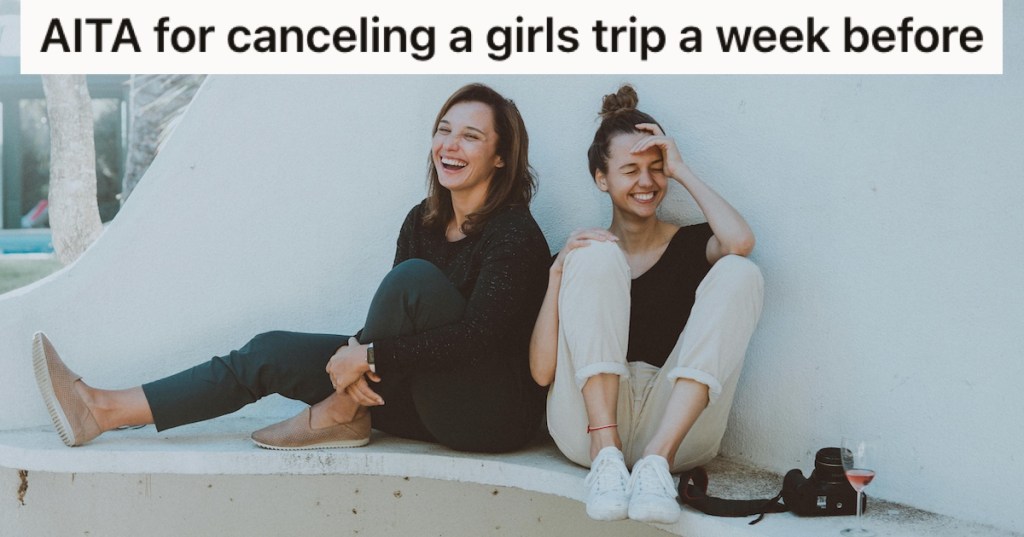 Two women laughing on a bench