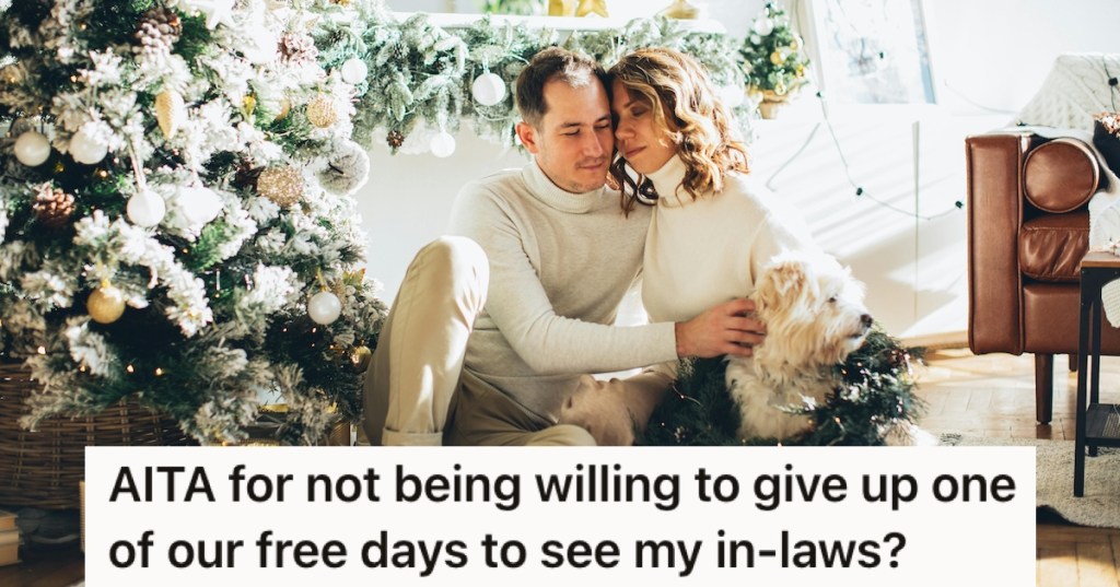 A couple and their dog by a Christmas tree