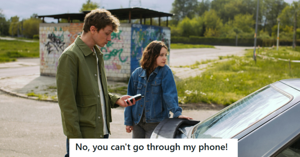man and woman standing on a street near a car