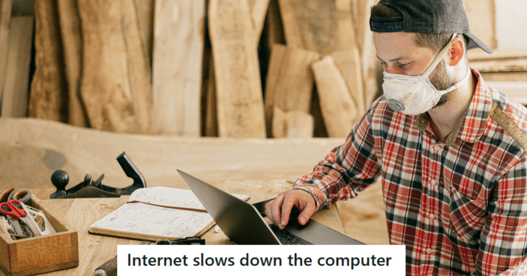 Man in mask working on a laptop