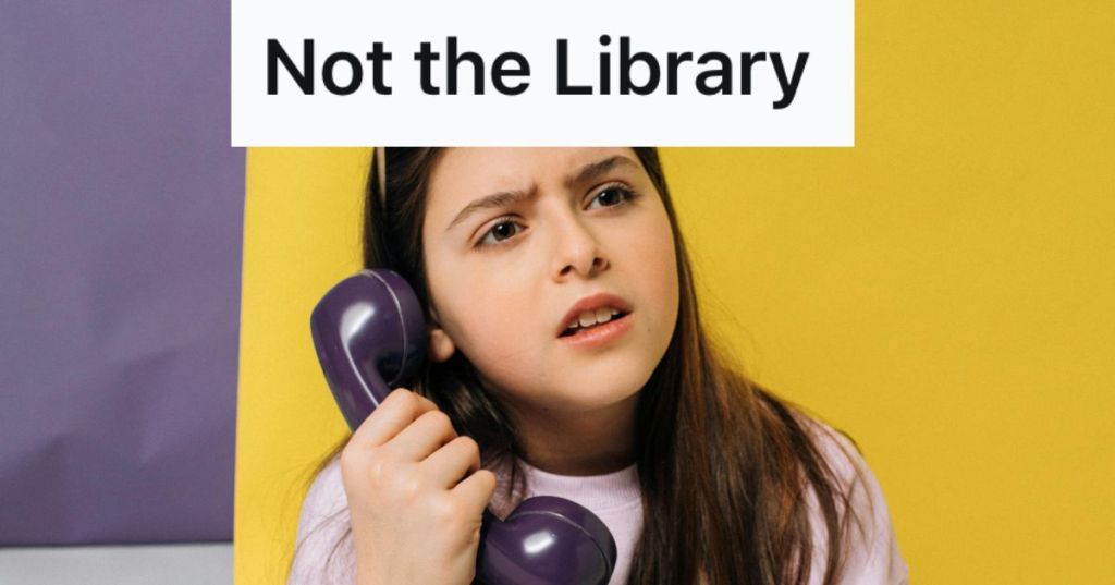 Young girl holding a telephone