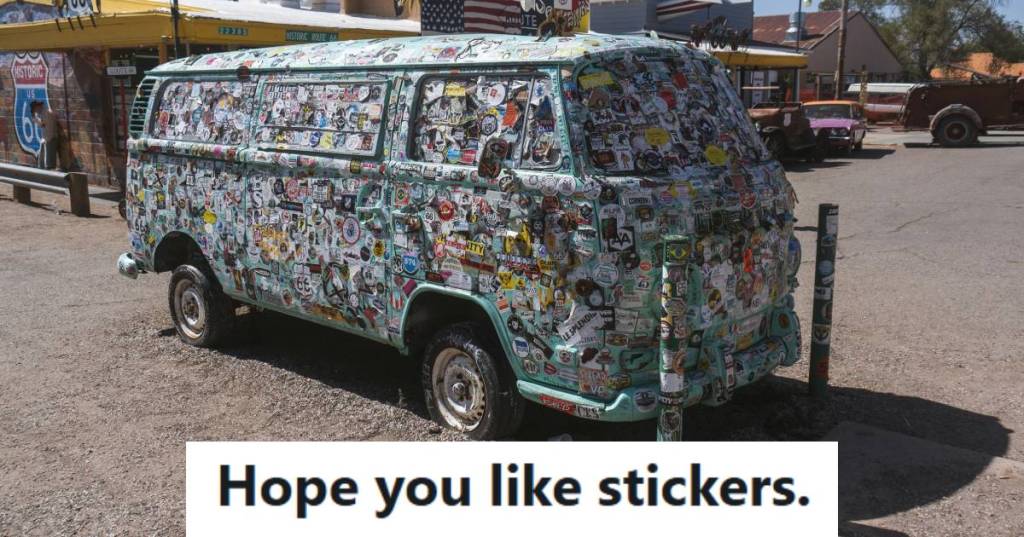 1960s Volkswagen Van covered in stickers and sitting on display