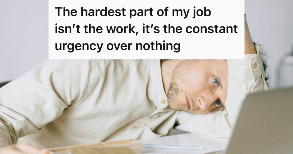 Tired employee lying on his desk looking at laptop