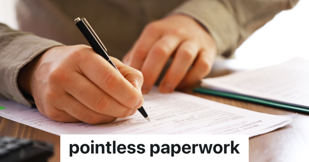 closeup of a man filling out paperwork with a pen