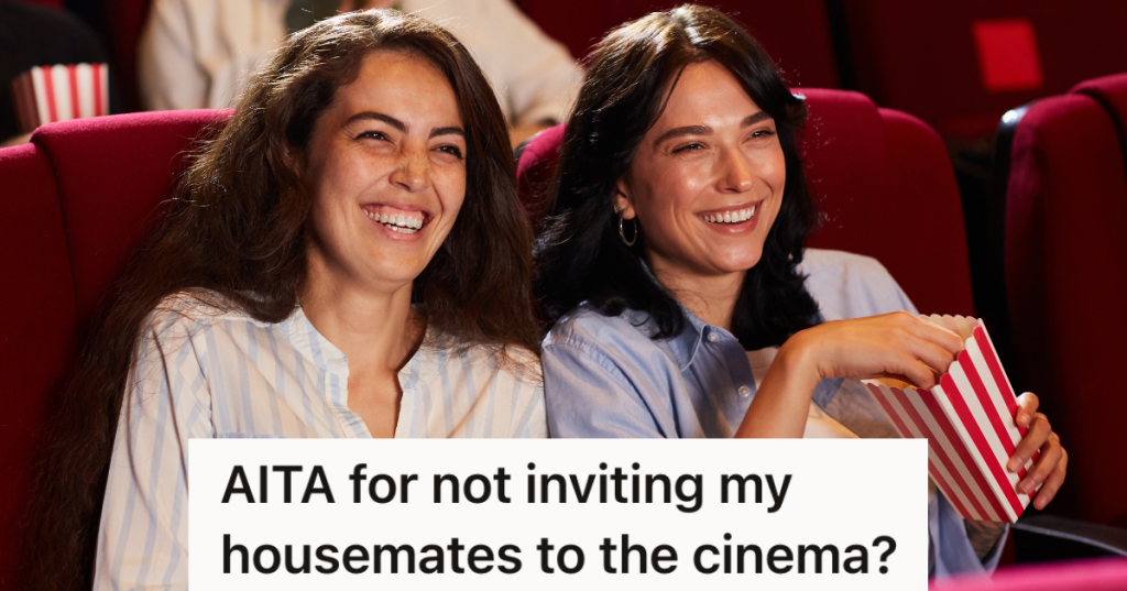 two women smiling while watching movie in movie theater