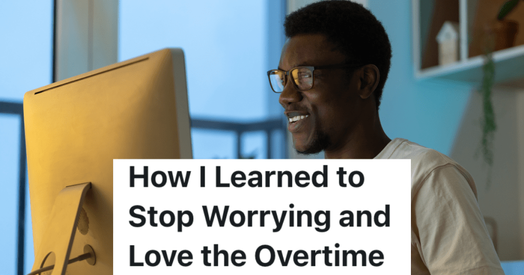 smiling man looking at a computer monitor