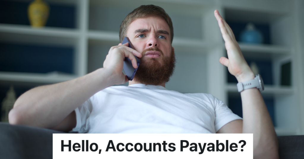 frustrated man in a white t-shirt talking on the phone