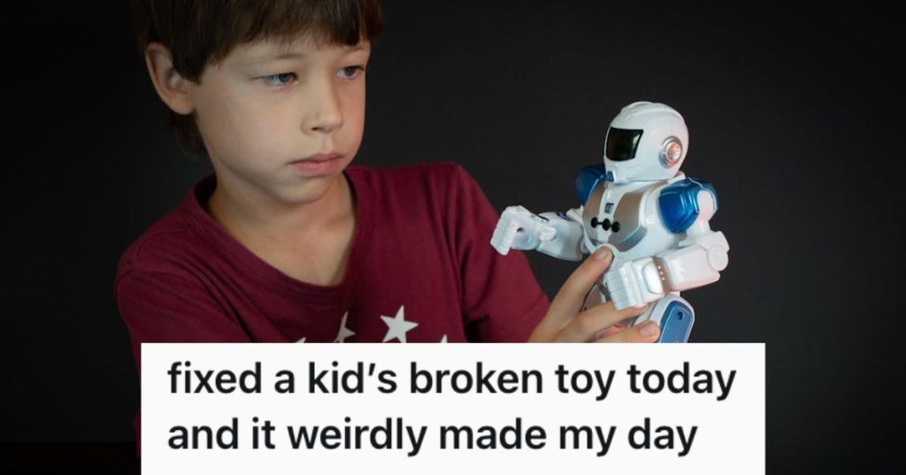 A little boy playing with his toy robot