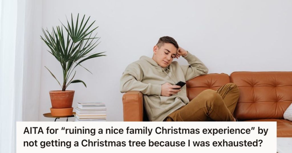 Teenager boy sitting on the couch and using his phone