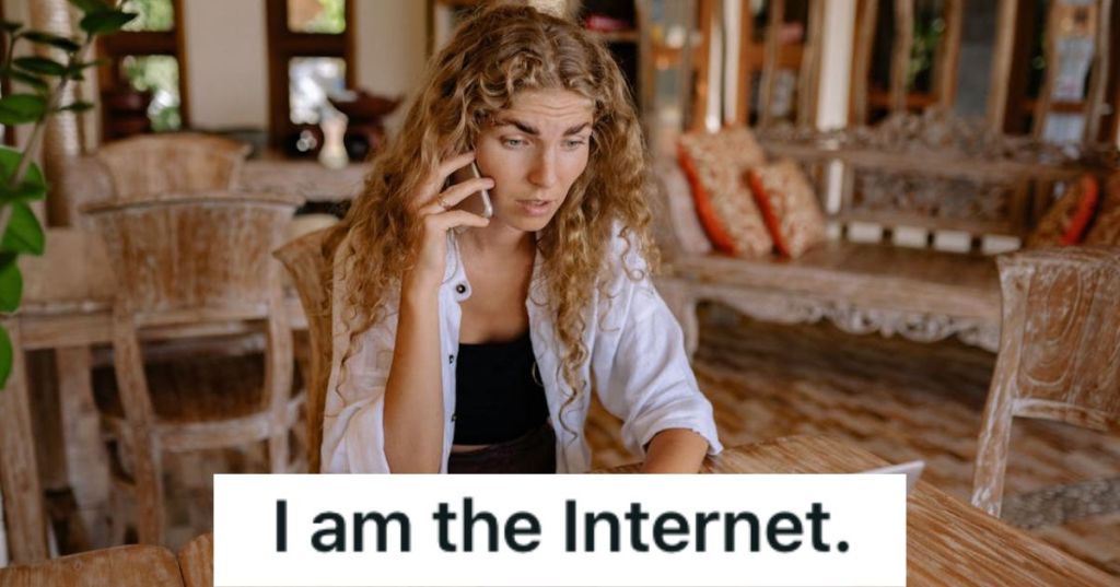 Woman talking to someone on the phone while looking at her laptop