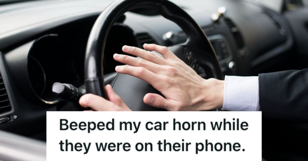 Man pressing the horn of the car