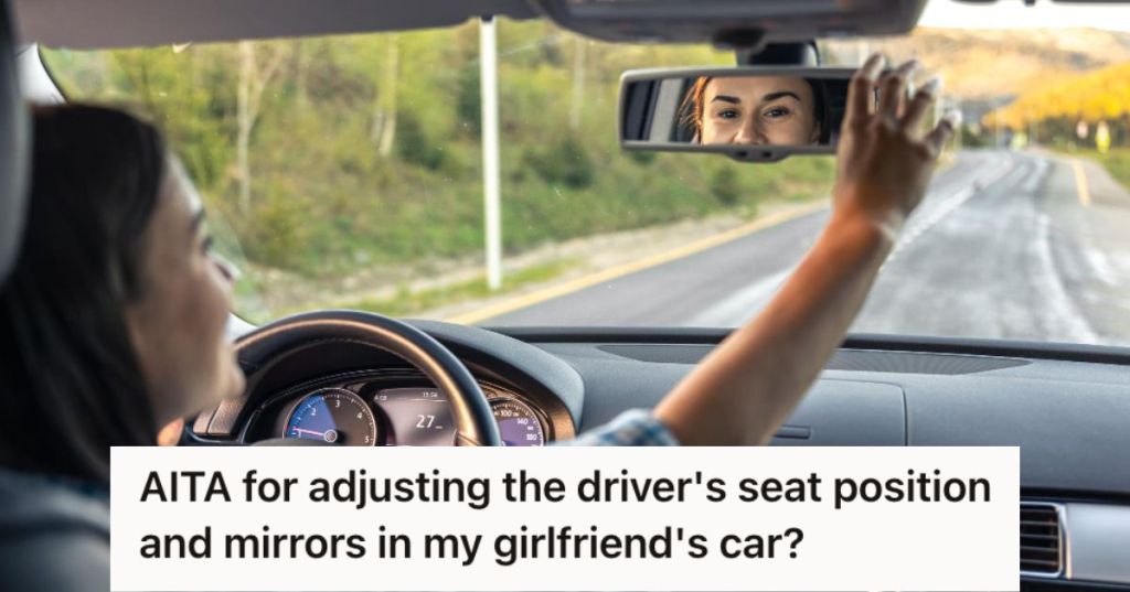 Woman adjusting the rear view mirror in her car.