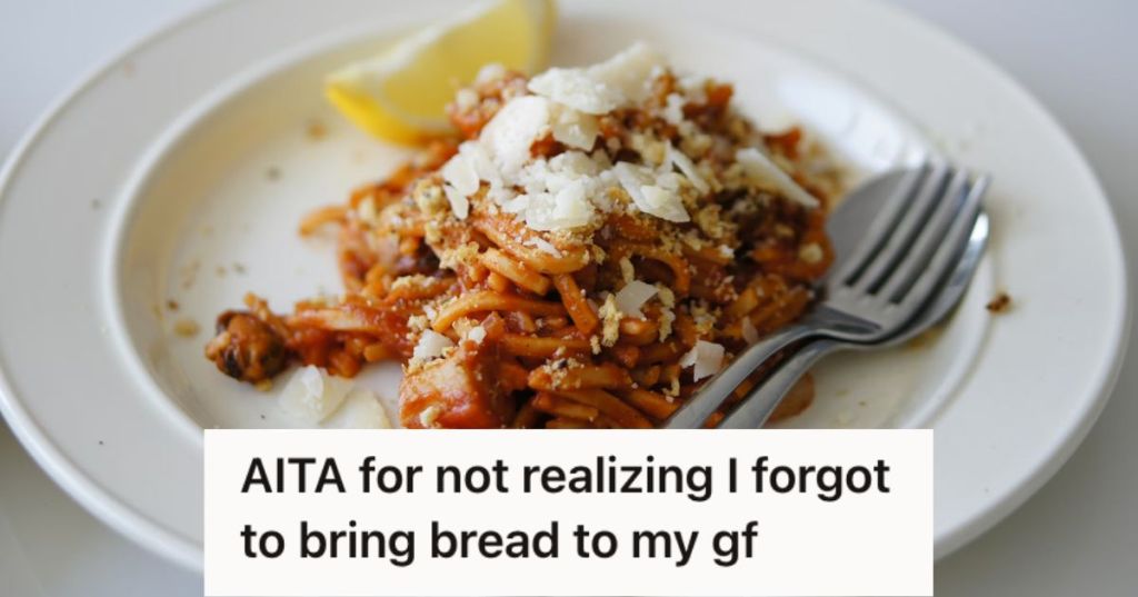 A plate of pasta with noodles, cheese, and lemon slice