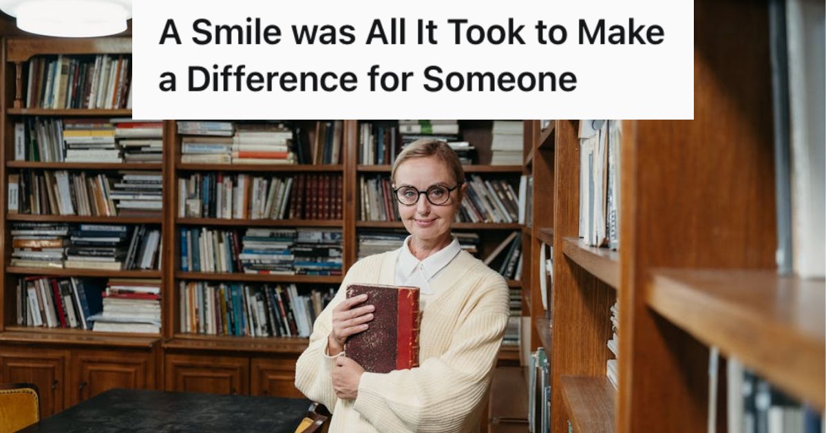 Librarian holding a book and smiling
