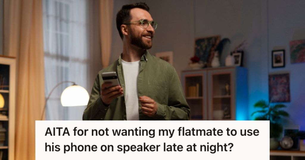 Man smiling while holding his cellphone