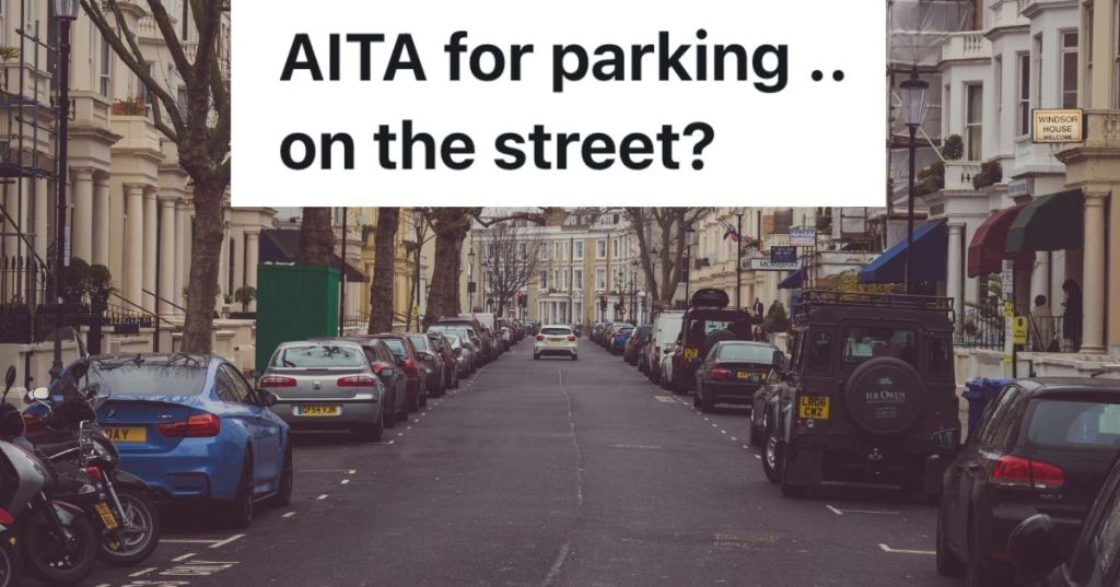 Street full of cars parked in front of houses