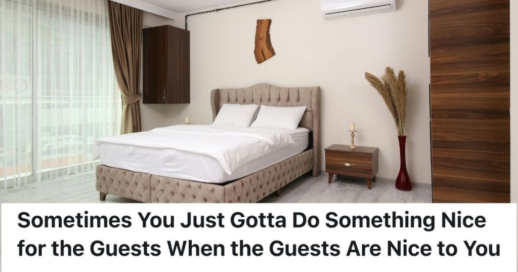 A hotel room with a made bed